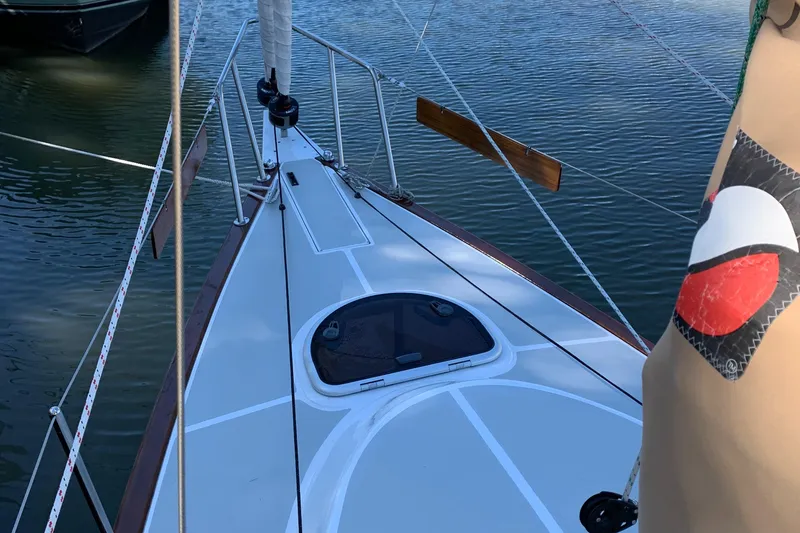 Slide: The Image of 2022 Tartan Fantail sailboat deck, moored on calm water. - 26