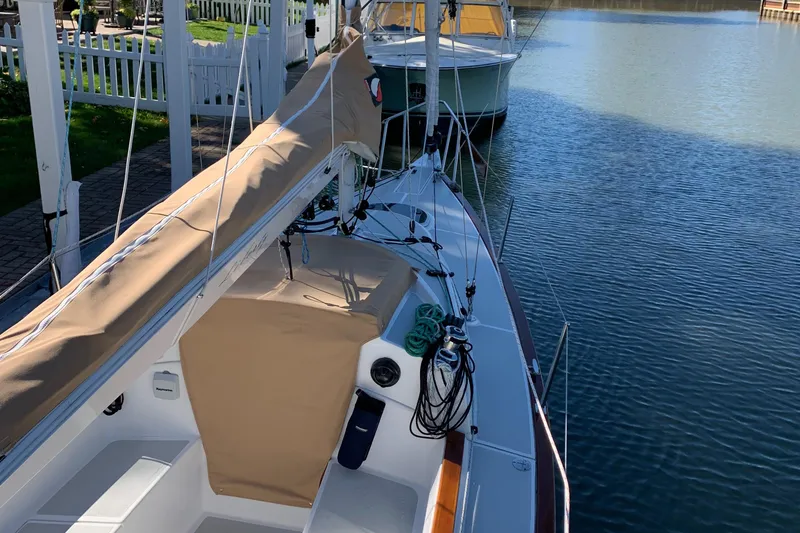 Slide: The Image of 2022 Tartan Fantail sailboat docked on calm water, featuring tan covers and sleek design. - 27