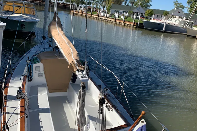 Slide: The Image of Sailboat docked in marina, Tartan Fantail 2022 model, calm water, sunny day. - 28