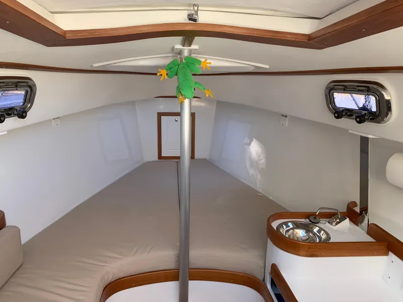 Slide: The Image of 2022 Tartan Fantail yacht interior with cozy cabin, portholes, and compact kitchenette. - 3
