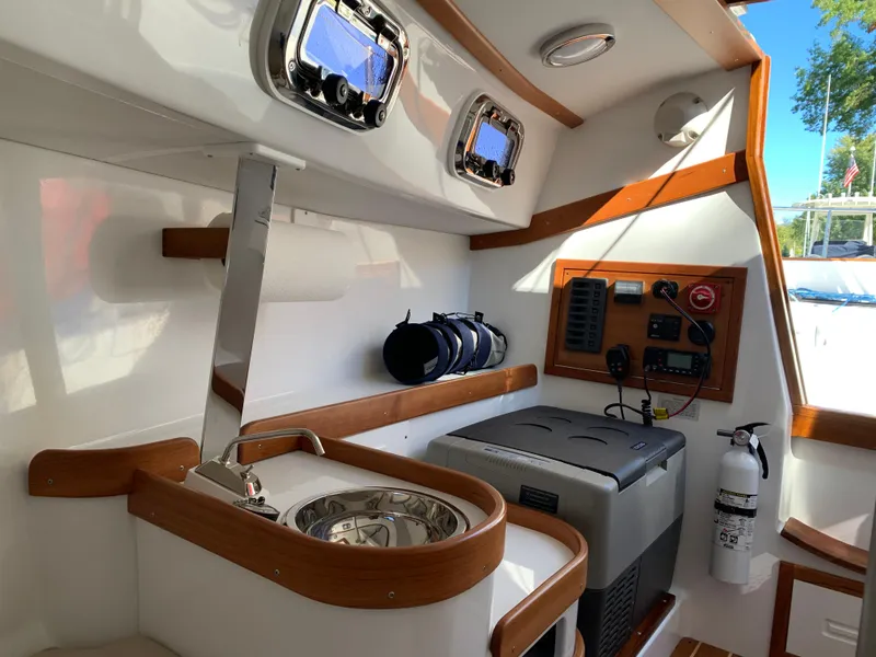 Slide: The Image of 2022 Tartan Fantail boat interior with sink, control panel, and fire extinguisher. - 4