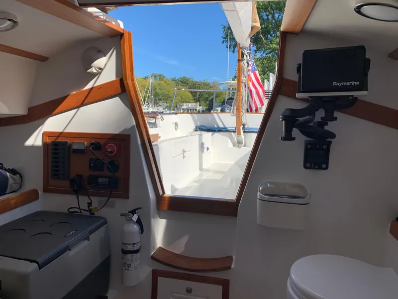 Slide: The Image of Interior view of 2022 Tartan Fantail sailboat, featuring navigation equipment and American flag. - 5