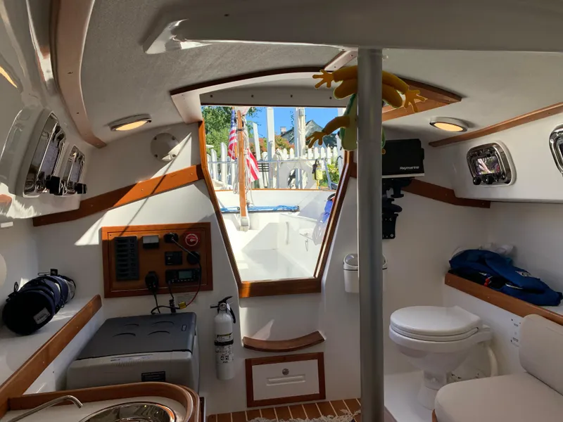 Slide: The Image of Interior of 2022 Tartan Fantail sailboat, featuring compact cabin with seating and equipment. - 7