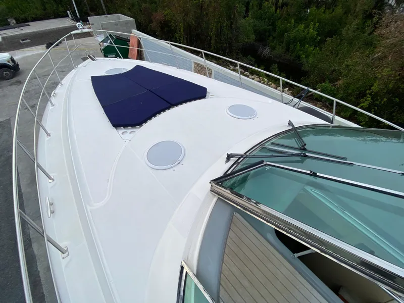Slide: The Image of 2006 Cruisers Yachts 52 Express boat deck with sunpad and railing. - 102