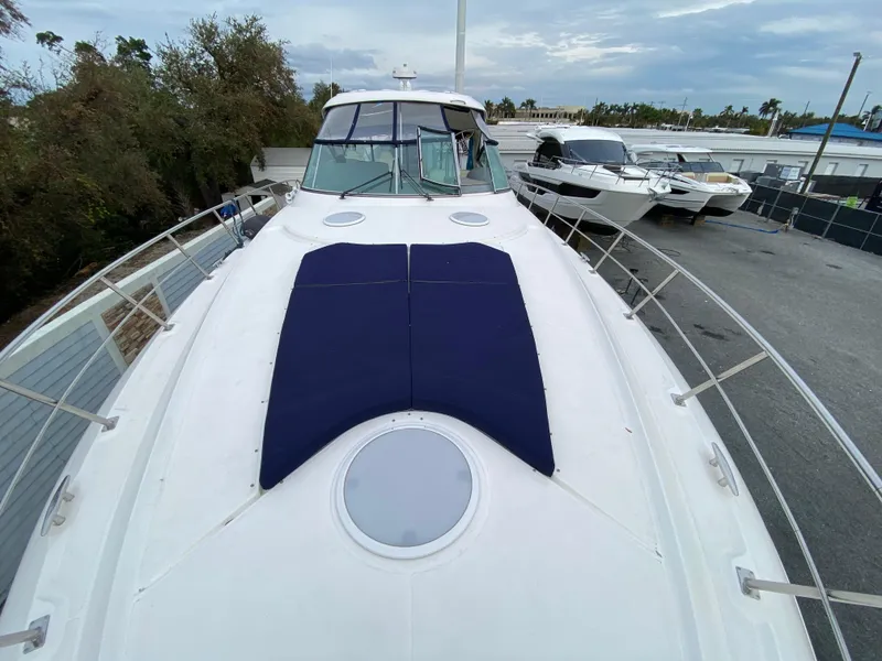 Slide: The Image of 2006 Cruisers Yachts 52 Express on display, featuring spacious deck and sleek design. - 104