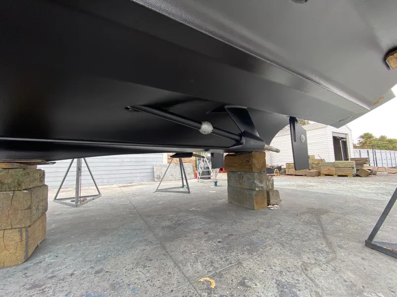 Slide: The Image of 2006 Cruisers Yachts 52 Express underbody on blocks, showcasing hull and support structure. - 106