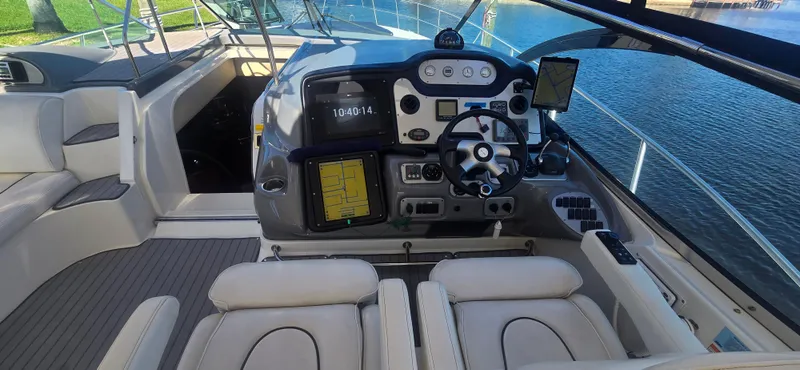 Slide: The Image of 2006 Cruisers Yachts 52 Express helm with modern navigation equipment and comfortable seating. - 12