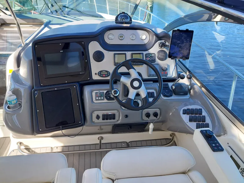 Slide: The Image of 2006 Cruisers Yachts 52 Express helm with modern navigation equipment and luxurious seating. - 13