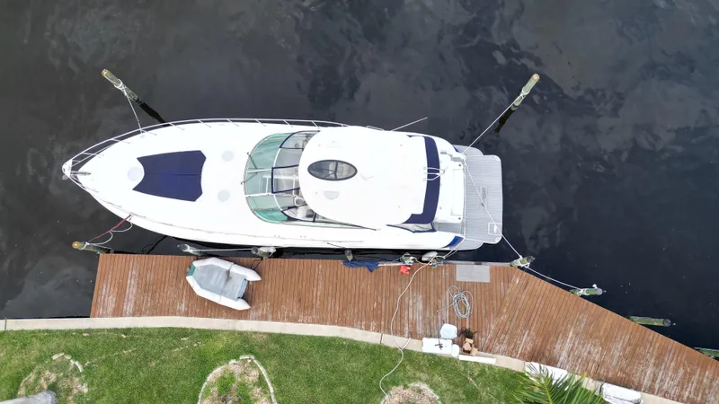 Slide: The Image of Aerial view of 2006 Cruisers Yachts 52 Express docked at a wooden pier. - 16