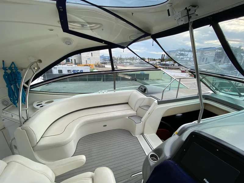 Slide: The Image of 2006 Cruisers Yachts 52 Express interior with white seating and panoramic windows. - 21