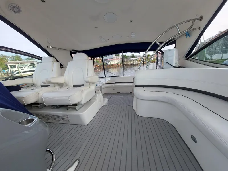 Slide: The Image of Luxurious interior of 2006 Cruisers Yachts 52 Express with white seating and panoramic windows. - 22