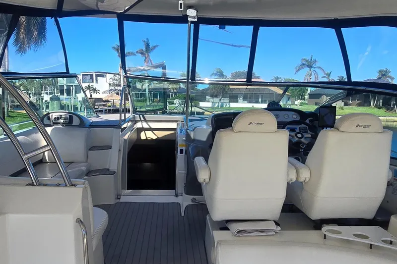 Slide: The Image of Interior view of 2006 Cruisers Yachts 52 Express, featuring helm and seating area. - 23