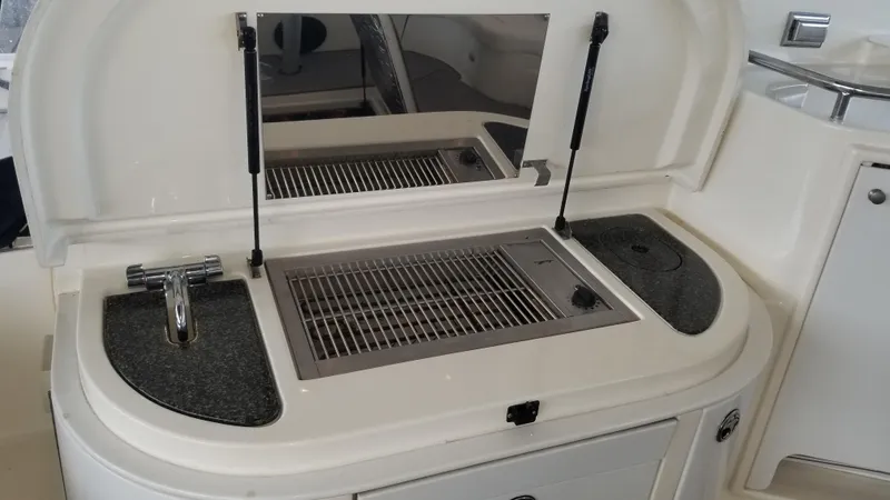 Slide: The Image of 2006 Cruisers Yachts 52 Express outdoor kitchen with grill and sink. - 24