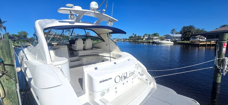 Slide: The Image of 2006 Cruisers Yachts 52 Express docked by a serene waterfront. - 29