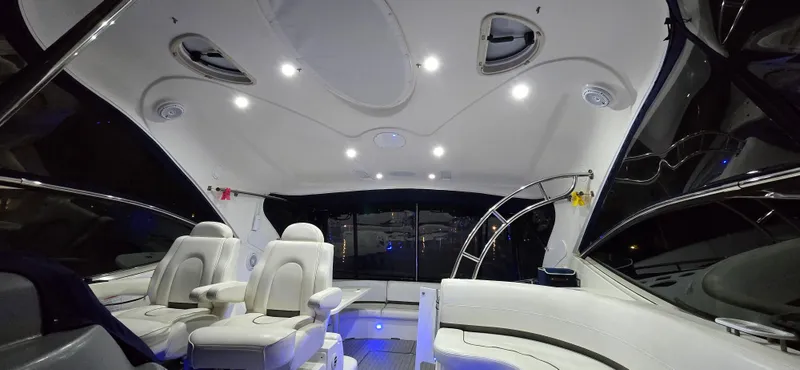 Slide: The Image of Interior of 2006 Cruisers Yachts 52 Express, featuring luxurious seating and modern lighting. - 33