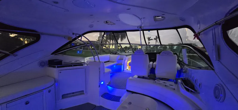 Slide: The Image of Interior of 2006 Cruisers Yachts 52 Express with ambient blue lighting. - 35