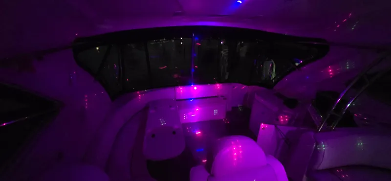 Slide: The Image of Interior of 2006 Cruisers Yachts 52 Express with ambient purple lighting. - 36