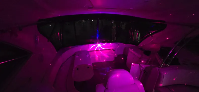 Slide: The Image of 2006 Cruisers Yachts 52 Express interior with vibrant pink lighting. - 38