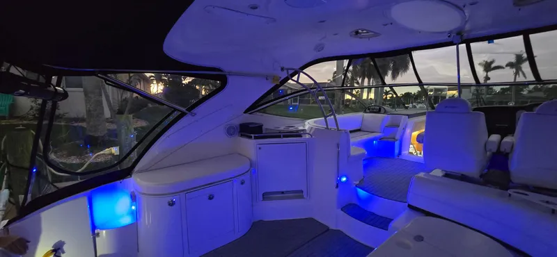Slide: The Image of Interior of 2006 Cruisers Yachts 52 Express with ambient blue lighting. - 39