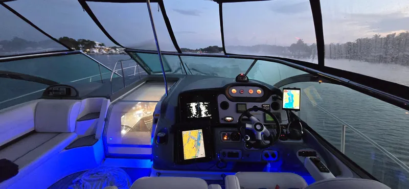 Slide: The Image of Interior view of 2006 Cruisers Yachts 52 Express cockpit with illuminated controls and navigation screens. - 4