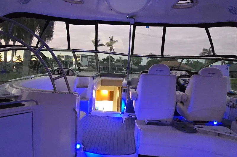 Slide: The Image of 2006 Cruisers Yachts 52 Express interior with blue lighting and palm tree view. - 40