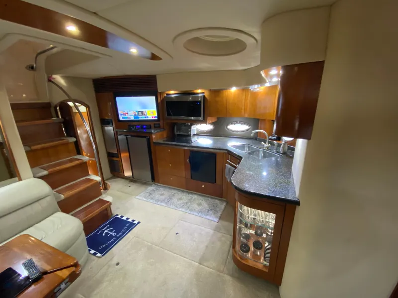Slide: The Image of Luxurious 2006 Cruisers Yachts 52 Express interior with modern kitchen and elegant wood finishes. - 42
