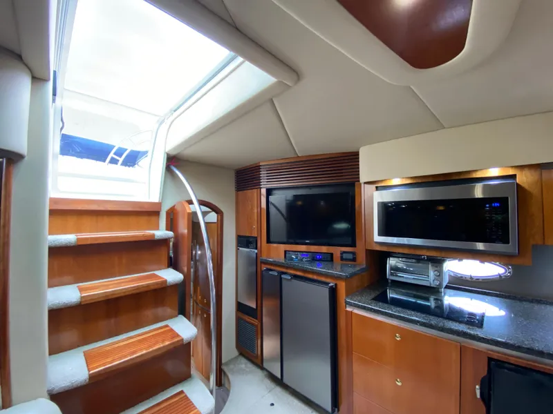 Slide: The Image of Interior of 2006 Cruisers Yachts 52 Express with modern kitchen and entertainment area. - 49