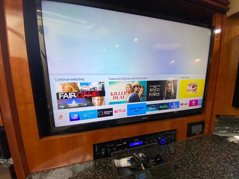 Slide: The Image of Entertainment system on 2006 Cruisers Yachts 52 Express, featuring streaming services on a large screen. - 51