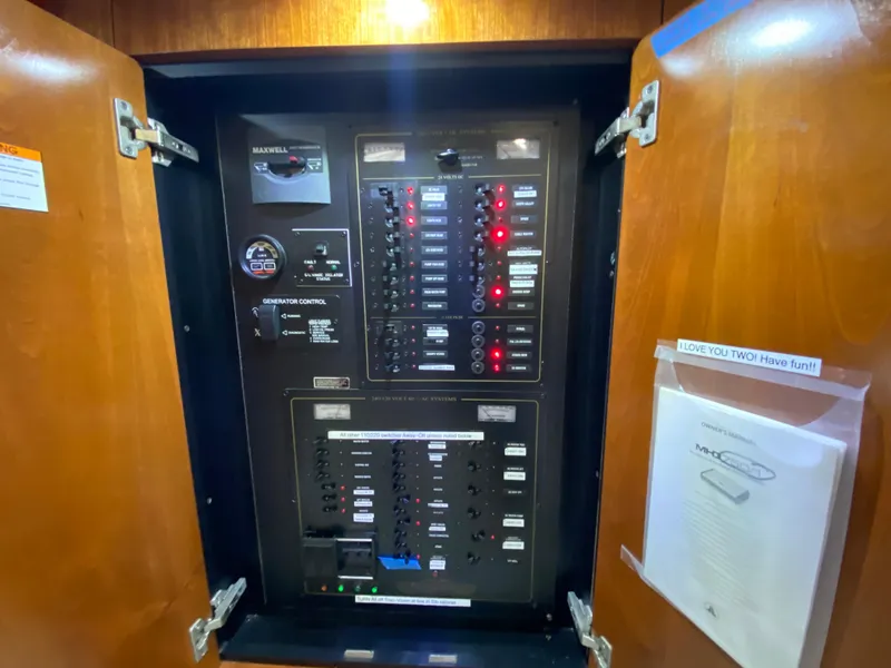 Slide: The Image of Electrical control panel inside 2006 Cruisers Yachts 52 Express. - 55