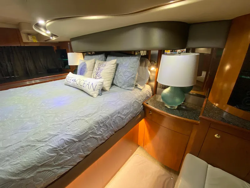 Slide: The Image of Luxurious bedroom interior of 2006 Cruisers Yachts 52 Express with elegant bedding and lamp. - 59