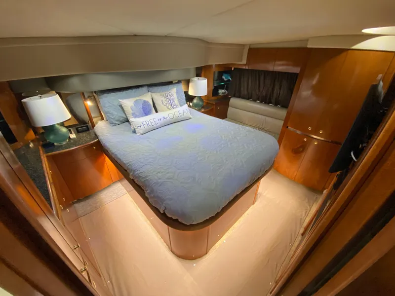 Slide: The Image of Luxurious bedroom interior of 2006 Cruisers Yachts 52 Express with cozy bedding and ambient lighting. - 63
