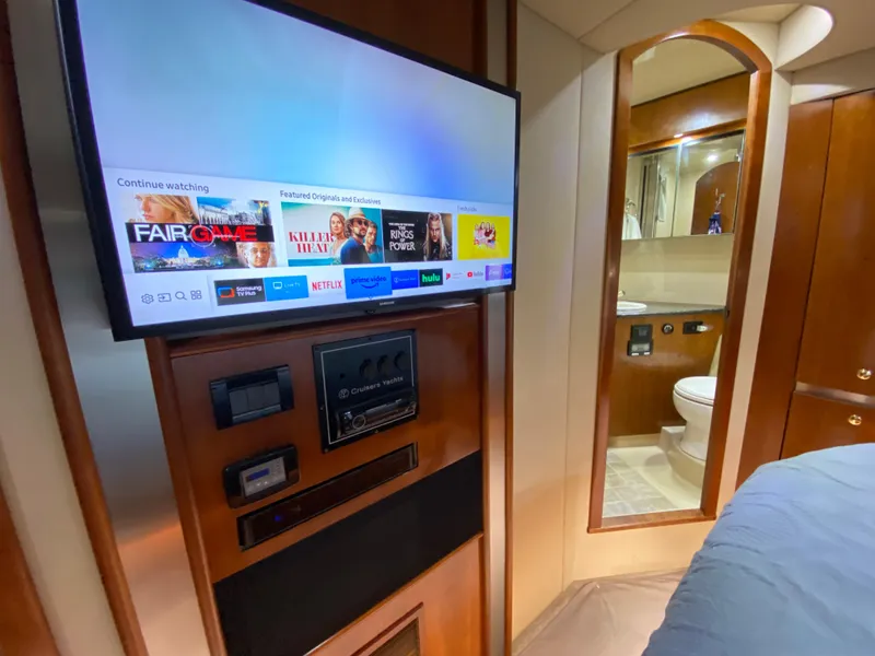 Slide: The Image of Interior of 2006 Cruisers Yachts 52 Express with TV and bathroom view. - 65
