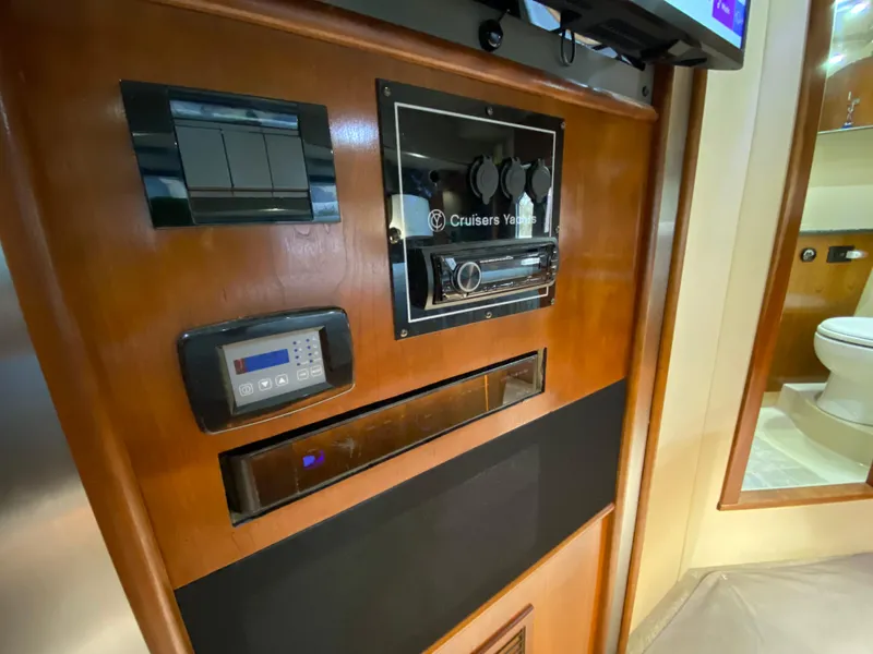 Slide: The Image of 2006 Cruisers Yachts 52 Express interior control panel with wood finish. - 66