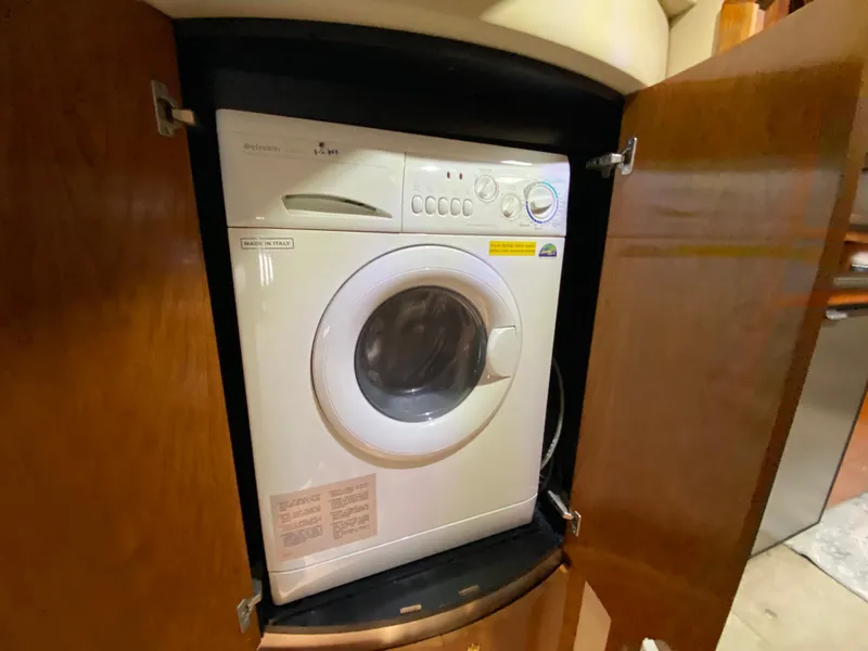 Slide: The Image of Washing machine inside 2006 Cruisers Yachts 52 Express wooden cabinet. - 67