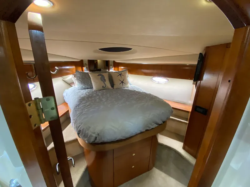 Slide: The Image of Luxurious cabin interior of 2006 Cruisers Yachts 52 Express with cozy bed and elegant wood finish. - 71