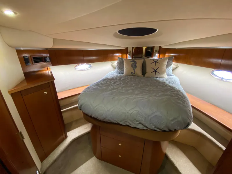 Slide: The Image of Luxurious bedroom interior of 2006 Cruisers Yachts 52 Express with elegant wood finish. - 72
