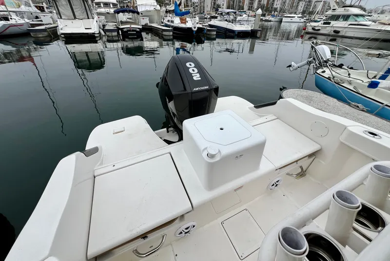 Slide: The Image of 2022 Bayliner Trophy T22CC boat with outboard motor docked in marina. - 14