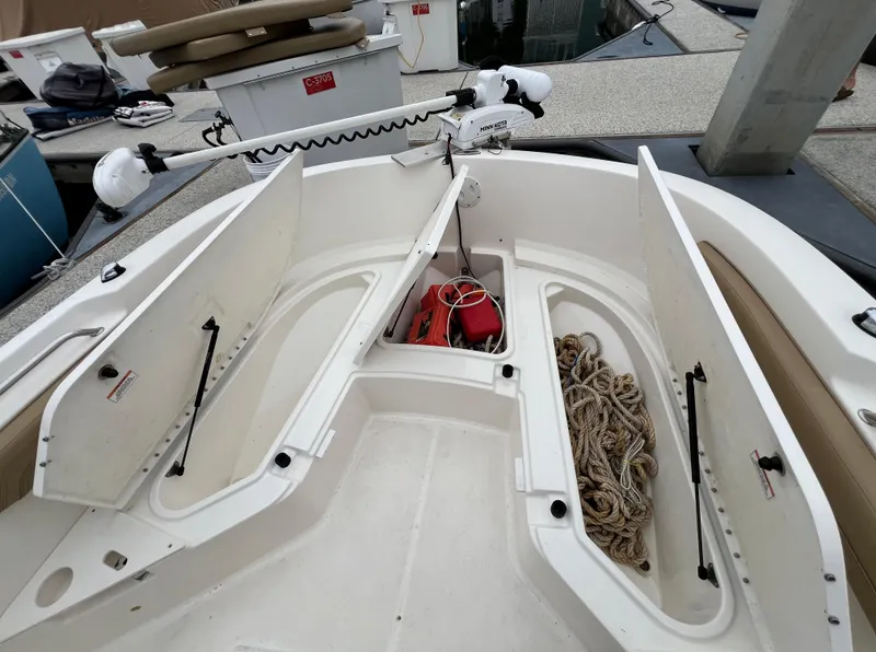 Slide: The Image of 2022 Bayliner Trophy T22CC boat storage compartments with ropes and equipment. - 30