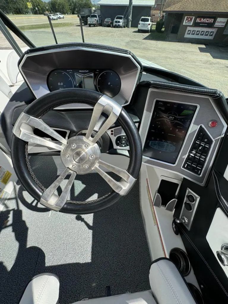 Slide: The Image of 2018 MasterCraft X23 boat dashboard with steering wheel and digital display. - 4