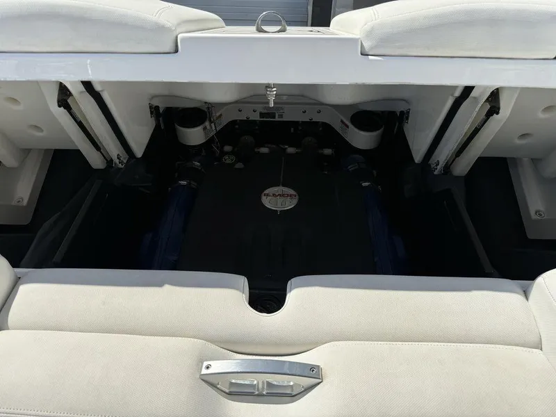 Slide: The Image of 2018 MasterCraft X23 boat engine compartment with open hatch and visible components. - 8