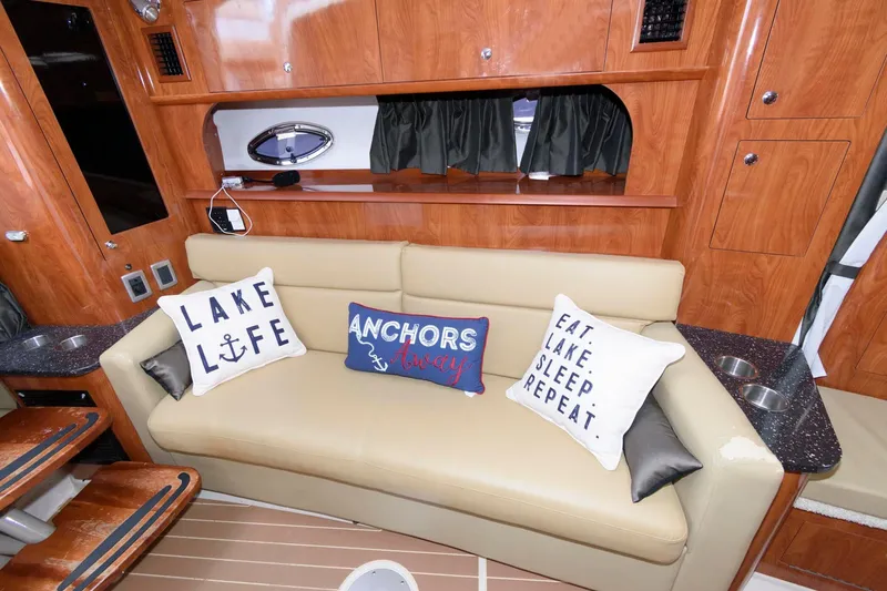 Slide: The Image of Luxurious 2008 Four Winns V338 yacht interior with decorative pillows on a beige sofa. - 11