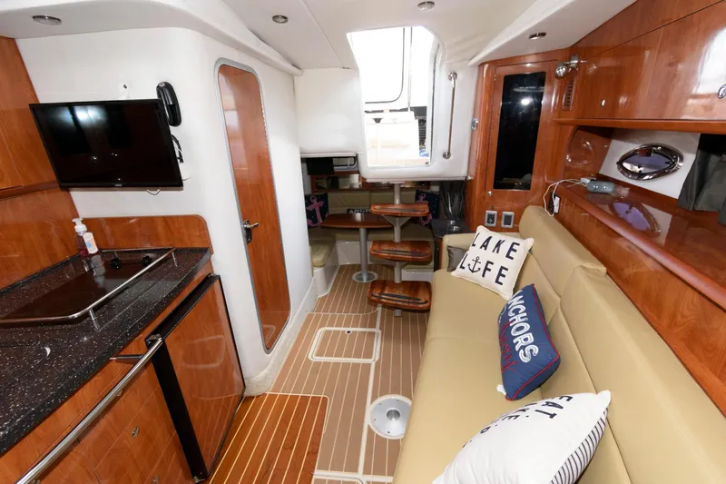 Slide: The Image of Interior of 2008 Four Winns V338 yacht with modern kitchen and cozy seating area. - 15