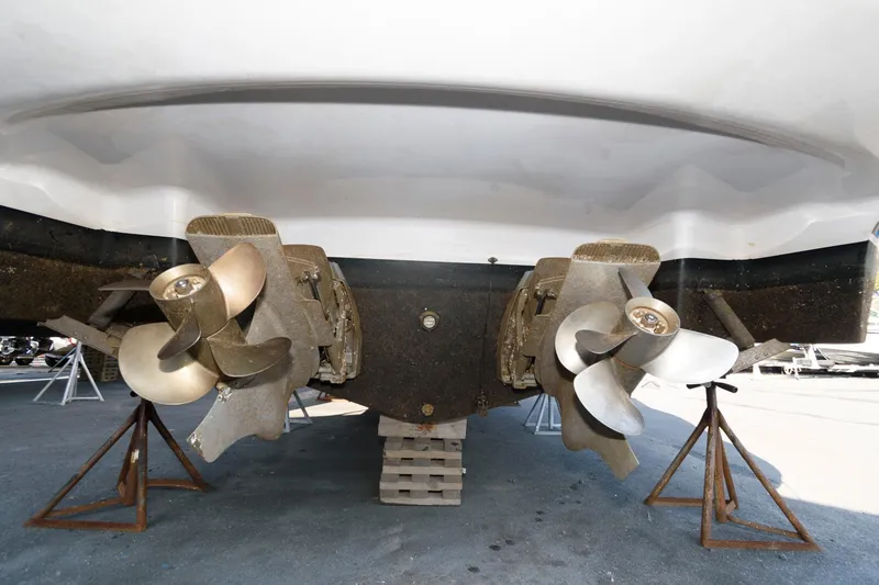Slide: The Image of 2008 Four Winns V338 boat propellers on stands, viewed from below. - 19