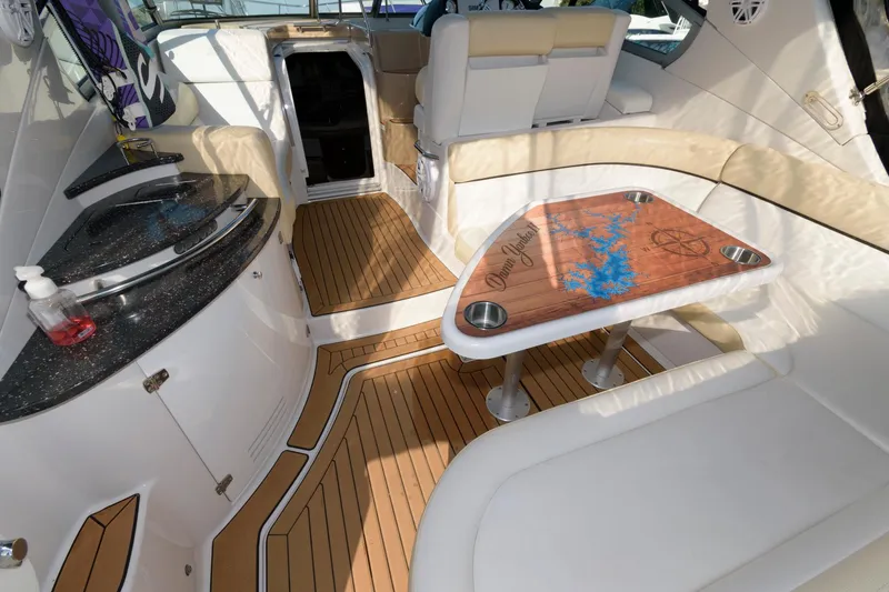 Slide: The Image of 2008 Four Winns V338 yacht interior with wood flooring and seating area. - 2