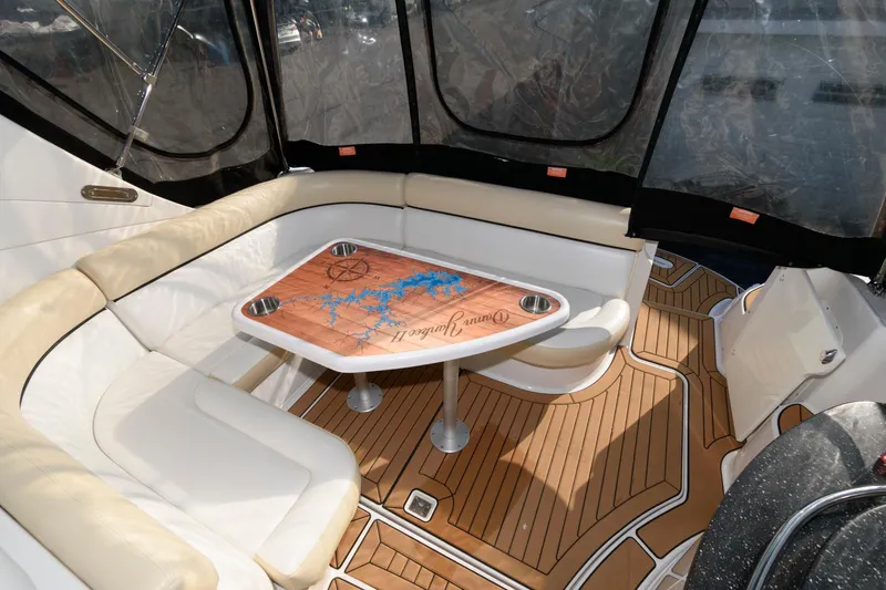 Slide: The Image of 2008 Four Winns V338 yacht interior with cushioned seating and wooden table. - 4