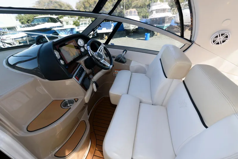 Slide: The Image of 2008 Four Winns V338 boat interior with white seating and modern dashboard. - 6