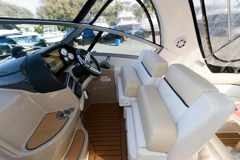 Slide: The Image of Interior of 2008 Four Winns V338 boat with beige seating and modern dashboard. - 7