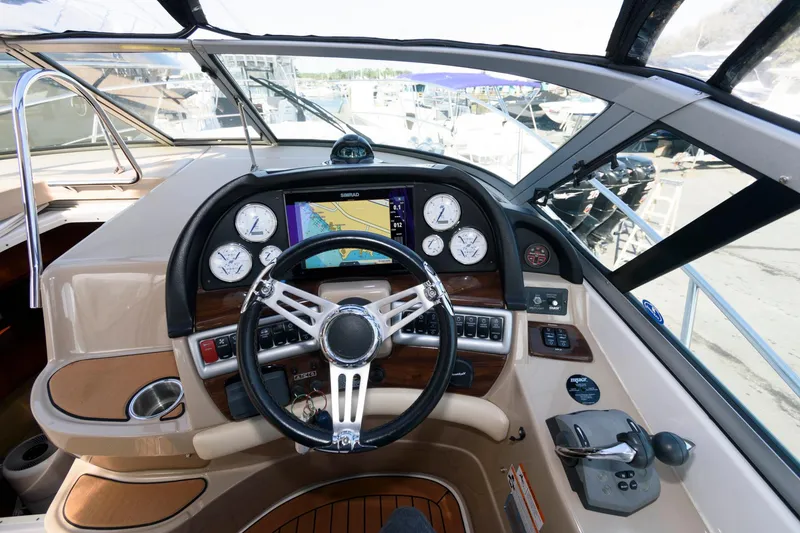 Slide: The Image of 2008 Four Winns V338 boat dashboard with steering wheel and navigation instruments. - 8