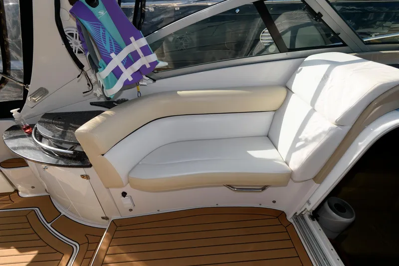 Slide: The Image of 2008 Four Winns V338 boat interior with white seating and wooden flooring. - 9