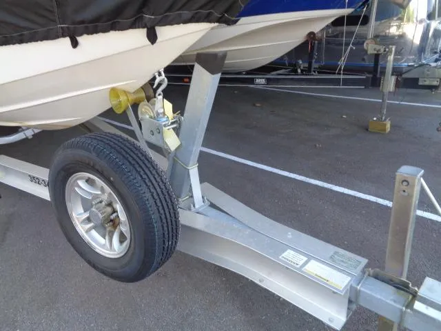 Slide: The Image of Trailer of a 2001 Warlock 29 World Class boat, featuring a sturdy wheel and hitch. - 12